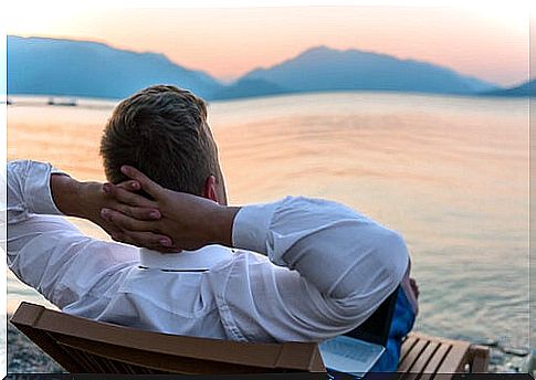 Man resting on the beach who has learned to manage work stress