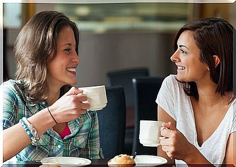 Girlfriends talking while having coffee