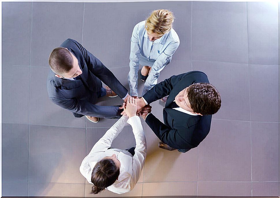 Group of people joining hands to represent the concept of social trust