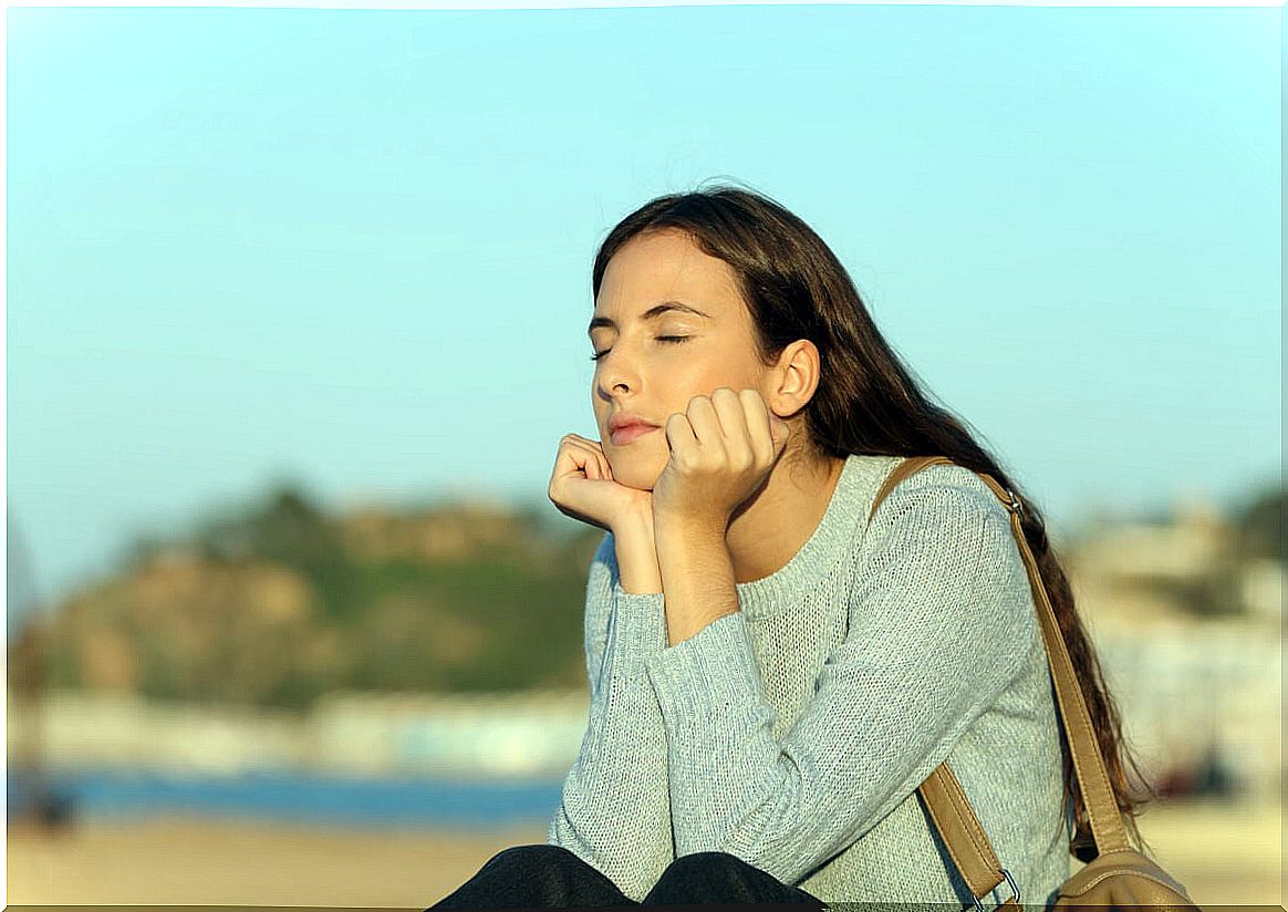 Woman with eyes closed outdoors