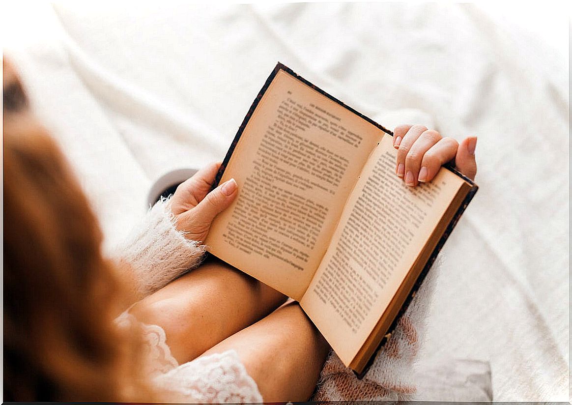 Woman reading a book in bed