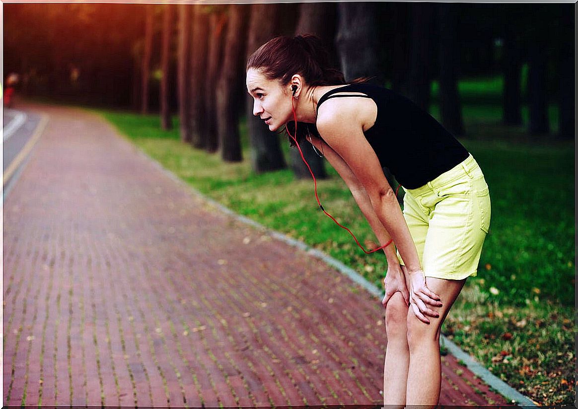 Exhausted woman after running thinking about developing self-efficacy