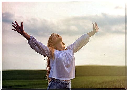 Woman with open arms showing her happiness