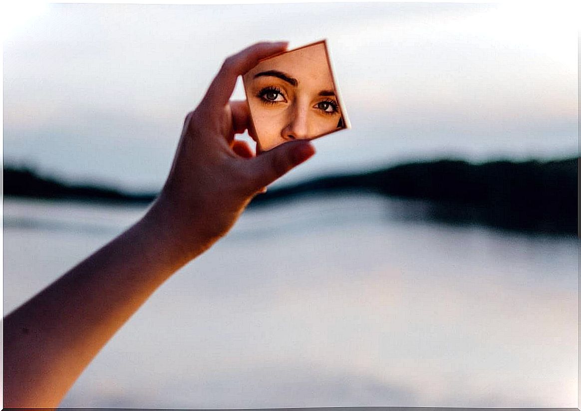 Woman looking at reflection in mirror