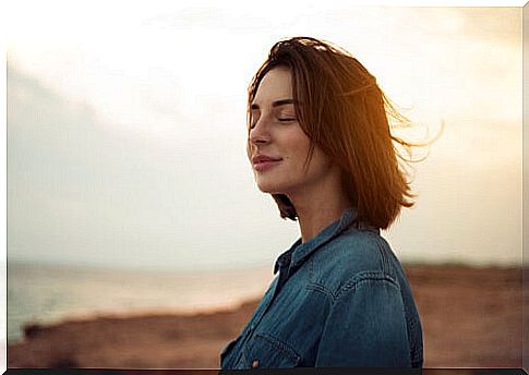 Woman with closed eyes outdoors