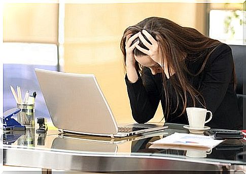 Woman stressed because she suffers from workplace harassment