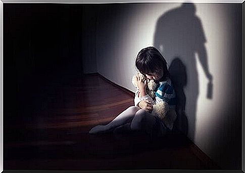 Boy holding his teddy bear for fear of abuse