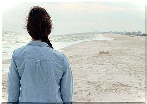 Woman in front of the sea thinking about and training the brain to keep hope