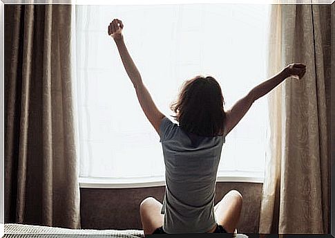 Woman stretching arms when waking up