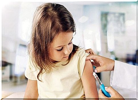 Nurse giving a little girl a vaccine