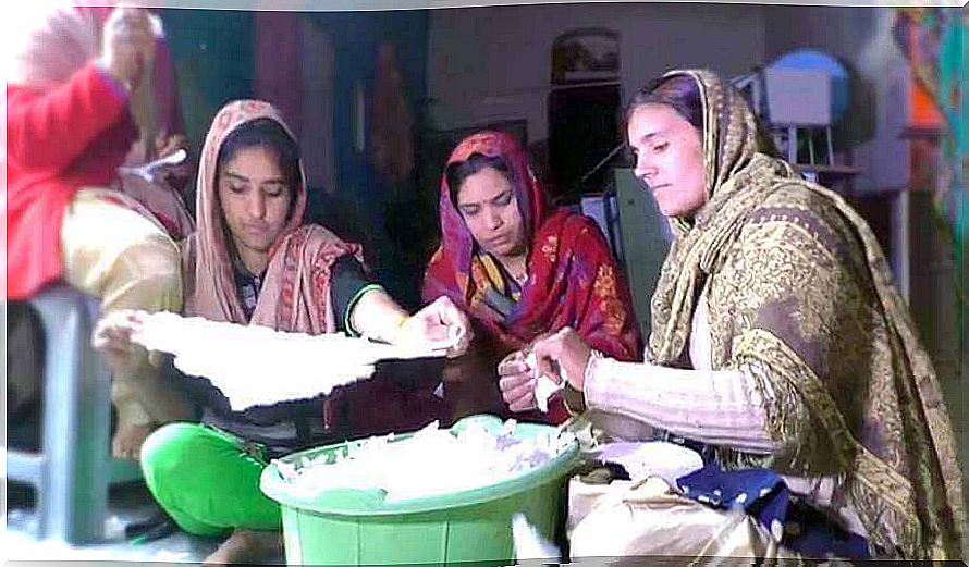 Women together making sanitary towels