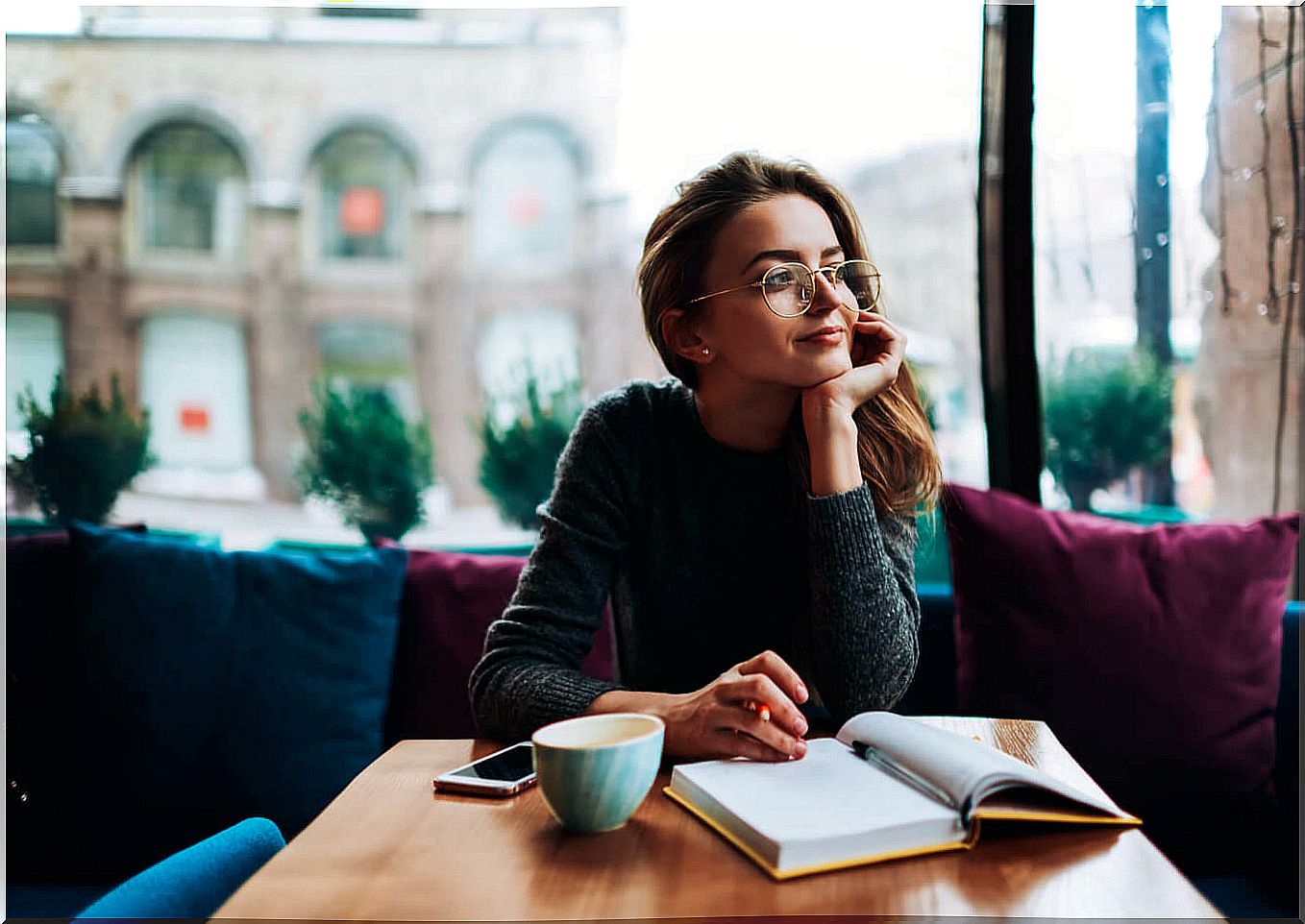 girl reading cafe thinking about seeking pleasure