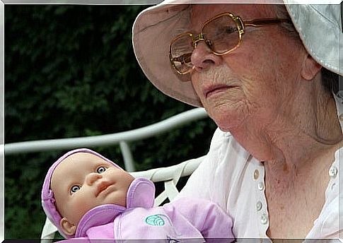 Grandmother playing with her granddaughter's doll