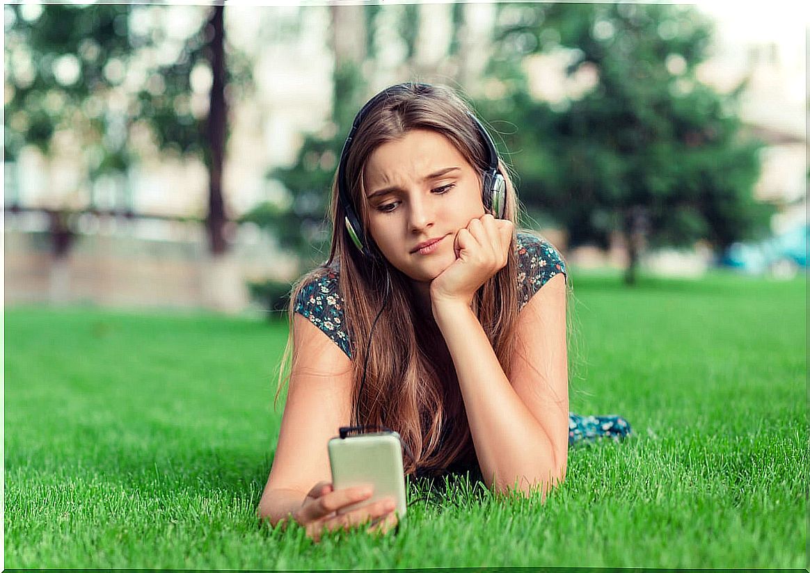 Woman listening to audio with mobile